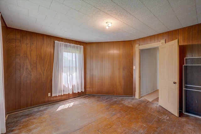3756 E County Rd N, Milton, WI 53563 - spare room featuring wood walls and hardwood / wood-style flooring