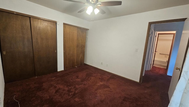 unfurnished bedroom with carpet flooring, two closets, and ceiling fan
