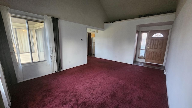 foyer with carpet flooring and vaulted ceiling