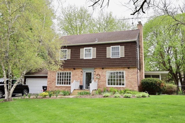 1651 E Ridge Rd, Beloit, WI 53511 - colonial home featuring a chimney, a front yard, and brick siding