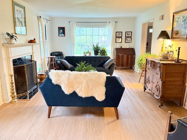 1651 E Ridge Rd, Beloit, WI 53511 - living room with light wood finished floors and a fireplace with flush hearth