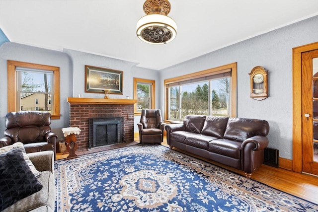 6309 12th St, Kenosha, WI 53144 - living area with a fireplace, a textured wall, plenty of natural light, and wood finished floors