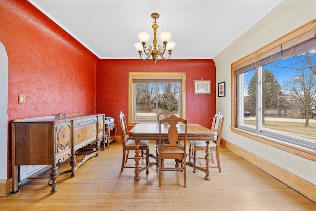 6309 12th St, Kenosha, WI 53144 - dining space with a notable chandelier, a healthy amount of sunlight, and light wood-style floors