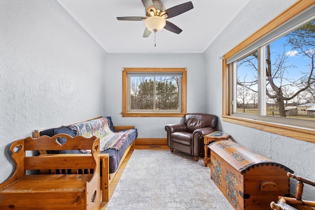 6309 12th St, Kenosha, WI 53144 - living area featuring wood finished floors, a ceiling fan, and a textured wall