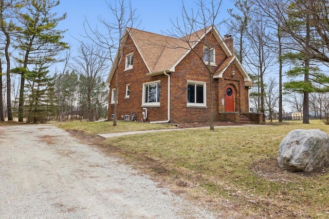 6309 12th St, Kenosha, WI 53144 - view of front of house featuring a front lawn, brick siding, roof with shingles, and a chimney