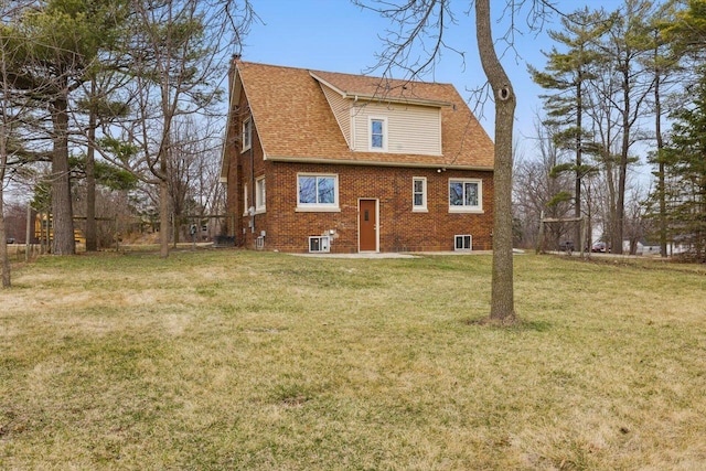 6309 12th St, Kenosha, WI 53144 - rear view of house with a yard, a shingled roof, and brick siding