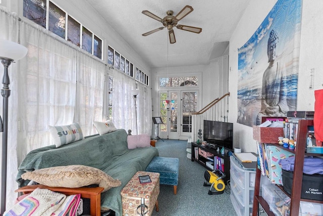living area featuring a ceiling fan and carpet floors