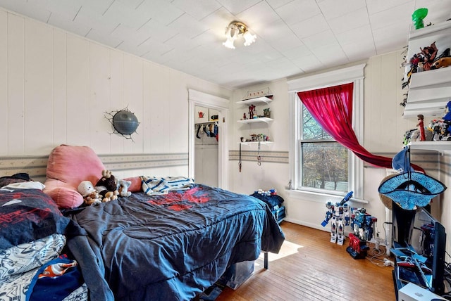bedroom featuring baseboards and hardwood / wood-style floors