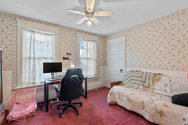 carpeted bedroom with a ceiling fan and wallpapered walls