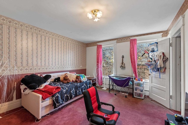 carpeted bedroom with a baseboard radiator and wallpapered walls