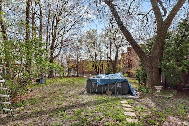 view of yard with a covered pool