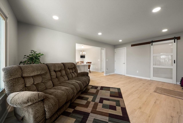 1111 Wauwatosa Rd, Cedarburg, WI 53012 - living room featuring light wood-style flooring, a barn door, and recessed lighting