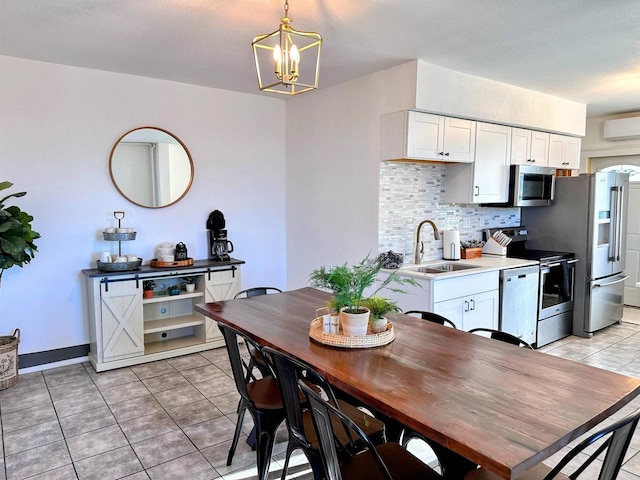 201 S Beaumont Rd, Prairie Du Chien, WI 53821 - kitchen with light tile patterned flooring, tasteful backsplash, appliances with stainless steel finishes, and a sink