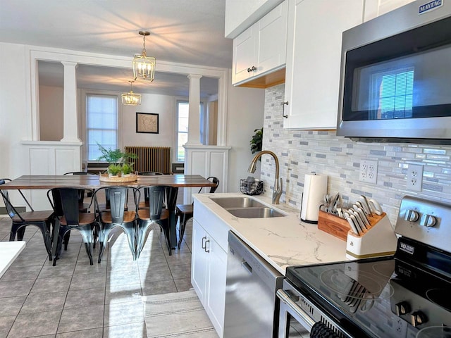 201 S Beaumont Rd, Prairie Du Chien, WI 53821 - kitchen featuring backsplash, appliances with stainless steel finishes, decorative columns, and a sink