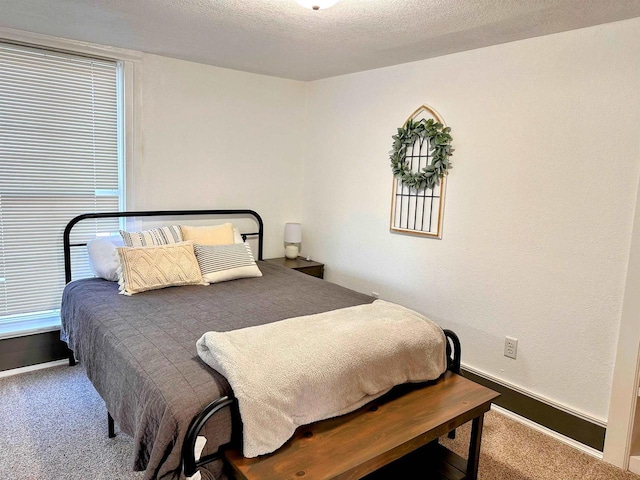 201 S Beaumont Rd, Prairie Du Chien, WI 53821 - carpeted bedroom with baseboards and a textured ceiling