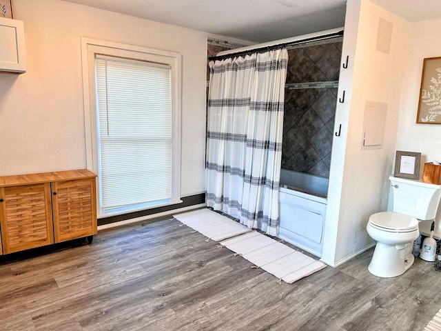 201 S Beaumont Rd, Prairie Du Chien, WI 53821 - bathroom featuring toilet, shower / tub combo, and wood finished floors