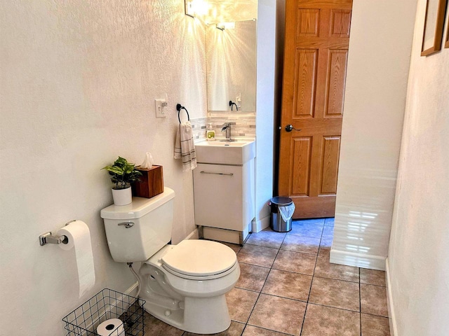 201 S Beaumont Rd, Prairie Du Chien, WI 53821 - bathroom with toilet, baseboards, tile patterned flooring, vanity, and a textured wall