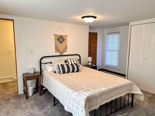 201 S Beaumont Rd, Prairie Du Chien, WI 53821 - carpeted bedroom featuring a textured ceiling and multiple closets