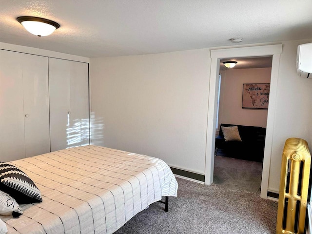 201 S Beaumont Rd, Prairie Du Chien, WI 53821 - carpeted bedroom featuring baseboards, a closet, and a wall mounted AC