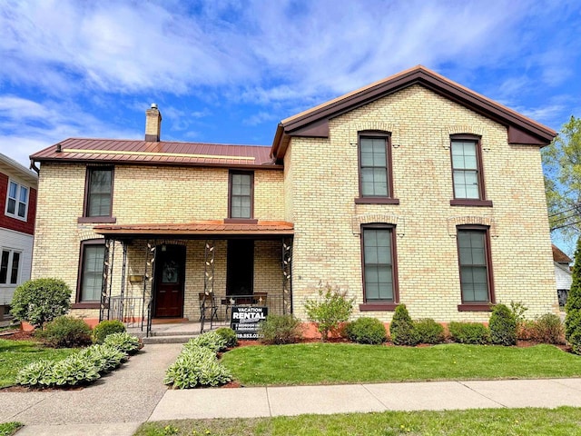 201 S Beaumont Rd, Prairie Du Chien, WI 53821 - view of front of home with a porch, brick siding, metal roof, and a chimney