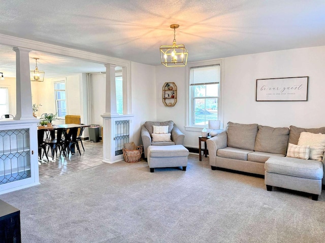 201 S Beaumont Rd, Prairie Du Chien, WI 53821 - living area featuring carpet, a notable chandelier, decorative columns, and baseboards