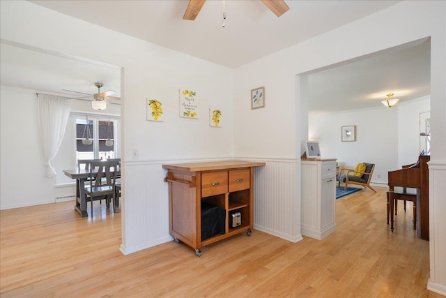 hall featuring light wood-style floors and wainscoting