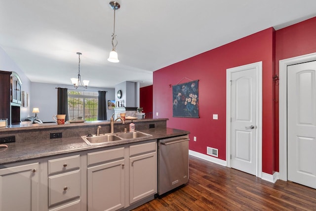 kitchen featuring a sink, visible vents, dishwasher, pendant lighting, and a chandelier