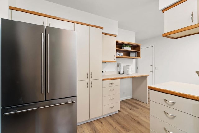 1511 Middleton St, Middleton, WI 53562 - kitchen featuring freestanding refrigerator, light countertops, light wood-style floors, white cabinetry, and open shelves