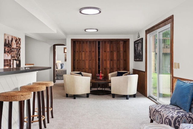 1511 Middleton St, Middleton, WI 53562 - living area with arched walkways, light colored carpet, a bar, and wainscoting
