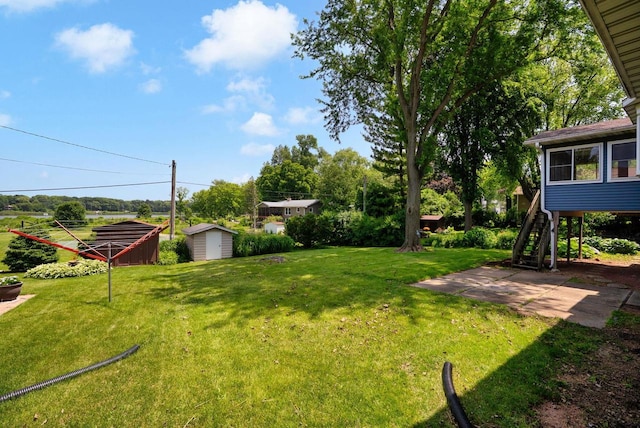 1511 Middleton St, Middleton, WI 53562 - view of grassy yard featuring a storage unit, a patio, and stairway