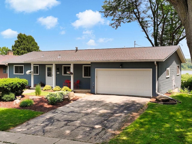 1511 Middleton St, Middleton, WI 53562 - ranch-style home with a garage, driveway, a shingled roof, and a front yard