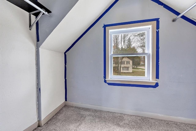 bonus room featuring vaulted ceiling, carpet, and baseboards