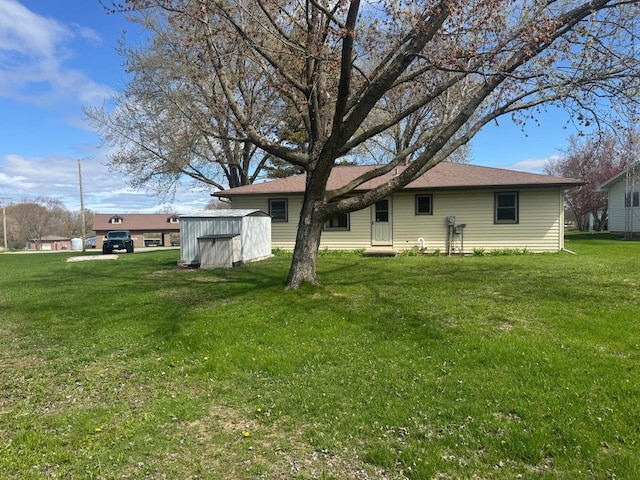 111 Grahl Ave, Eden, WI 53019 - rear view of property featuring a storage shed, an outdoor structure, and a lawn
