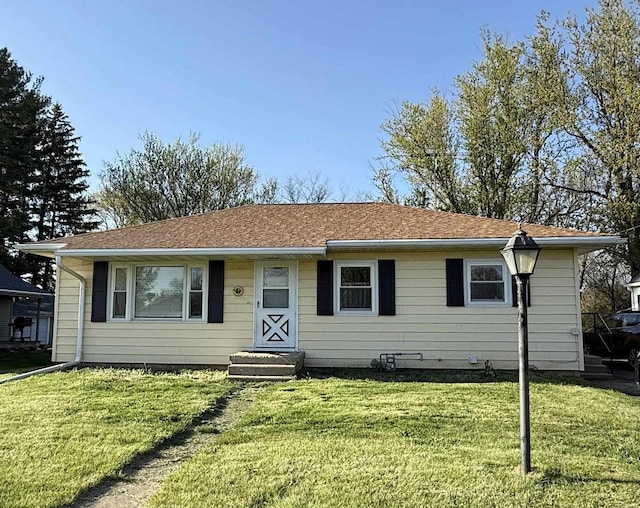 ranch-style home with a front lawn