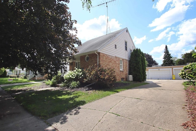 364 E 9th St, Fond Du Lac, WI 54935 - view of side of home with central air condition unit, brick siding, and a garage