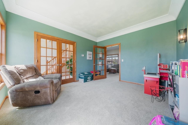 living area featuring carpet floors, french doors, and baseboards