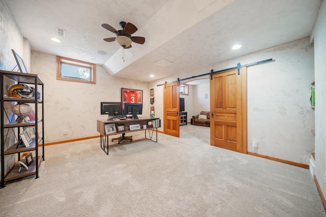 office space featuring ceiling fan, carpet, a barn door, and visible vents