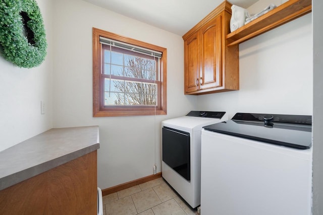 washroom featuring light tile patterned flooring, cabinet space, baseboards, and independent washer and dryer