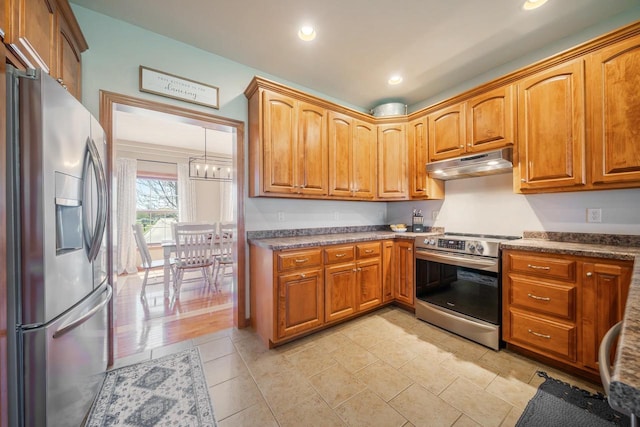 kitchen featuring under cabinet range hood, stainless steel appliances, brown cabinetry, and recessed lighting
