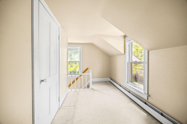 103 E Rollin St, Edgerton, WI 53534 - bonus room featuring a baseboard radiator, light carpet, vaulted ceiling, and baseboards