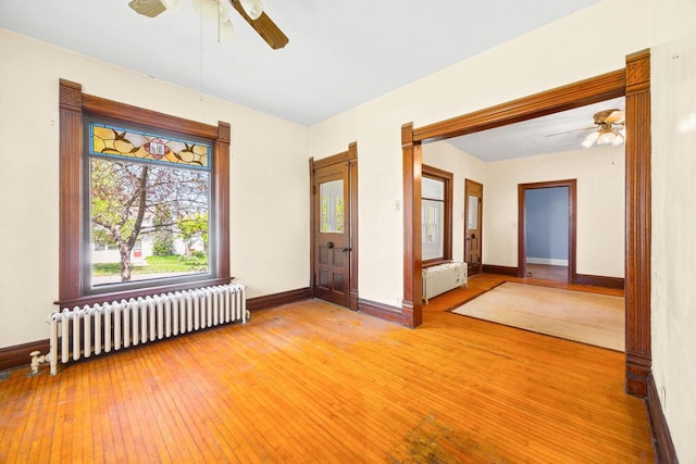 103 E Rollin St, Edgerton, WI 53534 - spare room featuring radiator heating unit, a ceiling fan, and baseboards