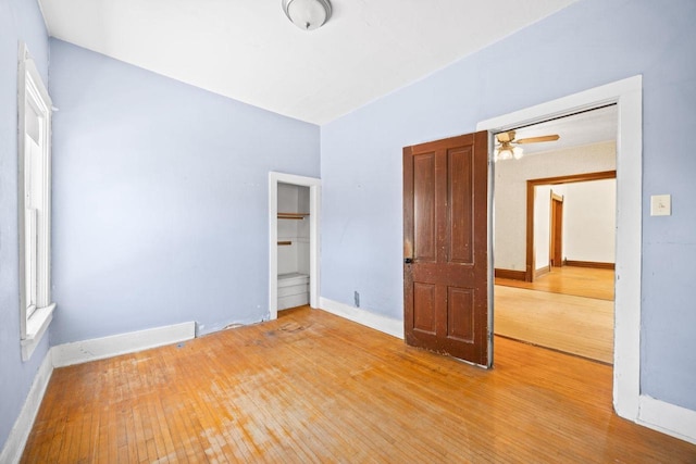 103 E Rollin St, Edgerton, WI 53534 - unfurnished bedroom with light wood finished floors, baseboards, and a closet