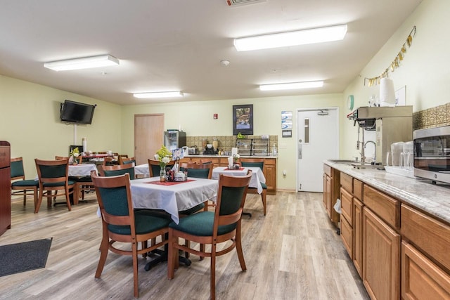 123 Center St Unit 301, Lake Geneva, WI 53147 - dining space featuring light wood finished floors and visible vents