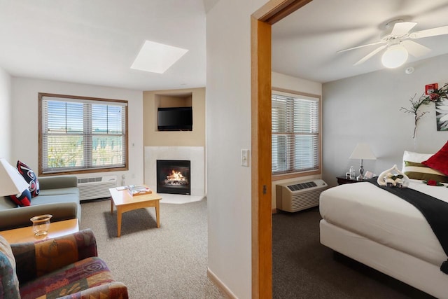 123 Center St Unit 301, Lake Geneva, WI 53147 - interior space with an AC wall unit, a skylight, carpet, and a warm lit fireplace