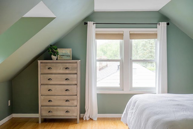 201 N Hillside Ter, Madison, WI 53705 - bedroom with lofted ceiling, light wood finished floors, multiple windows, and baseboards