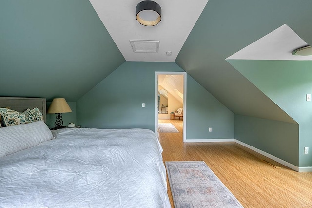 201 N Hillside Ter, Madison, WI 53705 - bedroom featuring wood finished floors, lofted ceiling, and baseboards