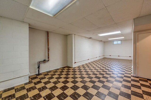 201 N Hillside Ter, Madison, WI 53705 - below grade area featuring tile patterned floors, a drop ceiling, and concrete block wall