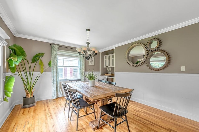 201 N Hillside Ter, Madison, WI 53705 - dining area featuring a chandelier, light wood-style flooring, baseboards, ornamental molding, and wainscoting