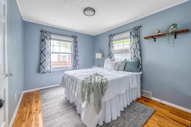 201 N Hillside Ter, Madison, WI 53705 - bedroom featuring multiple windows, light wood finished floors, and baseboards