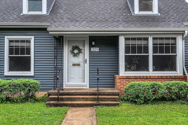 201 N Hillside Ter, Madison, WI 53705 - entrance to property with roof with shingles, a yard, and brick siding